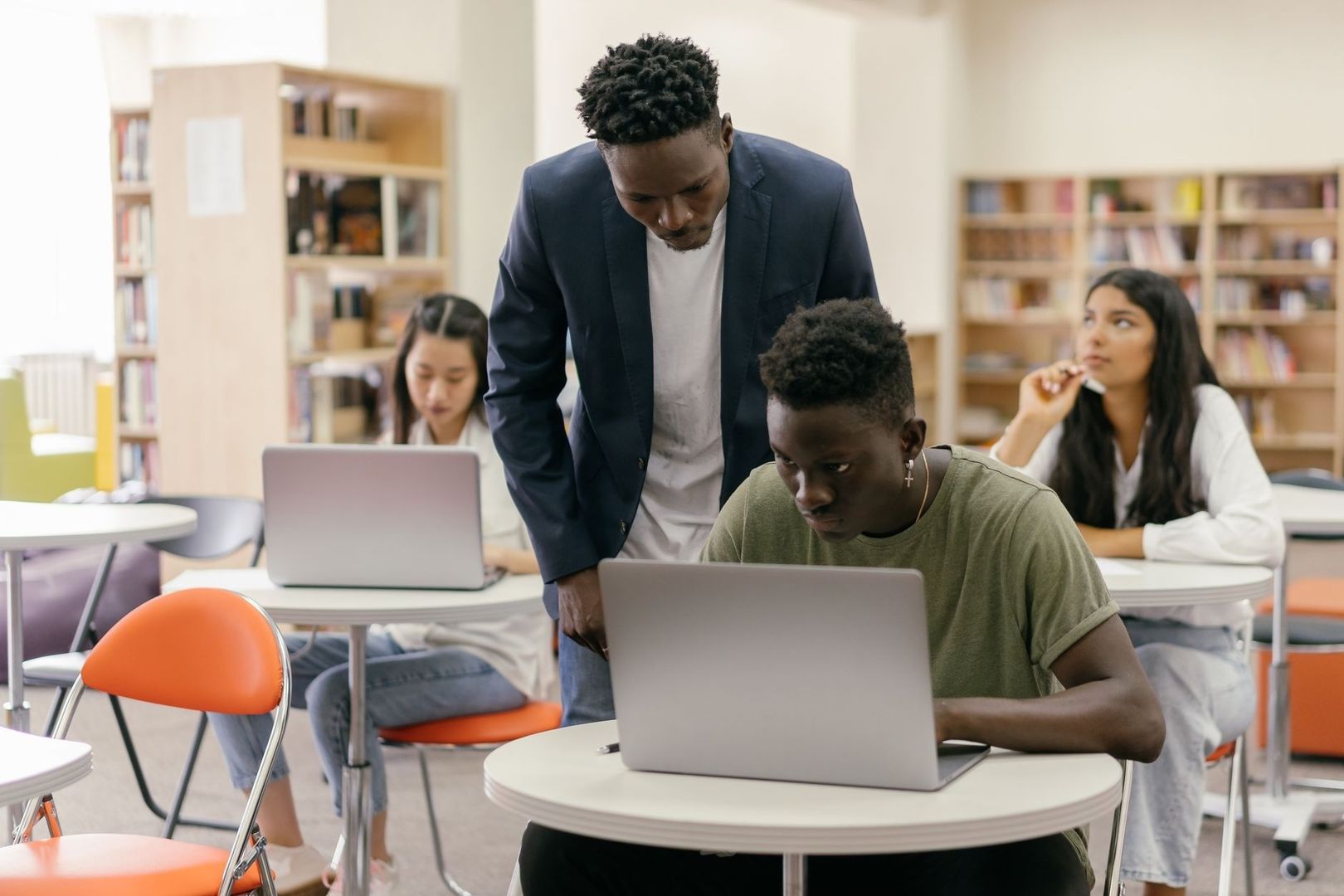 College students work together on laptops in a classroom